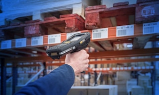 Operators use RF scanners to take inventory in the warehouse Operators use RF scanners to take inventory in the warehouse